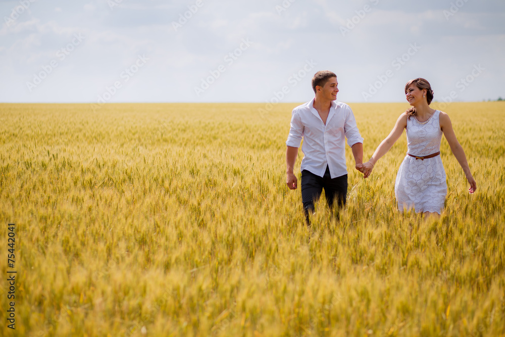 series. a love story. couple runs in the wheat field and smiling