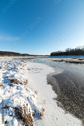 beautiful snowy winter landscape with frozen river