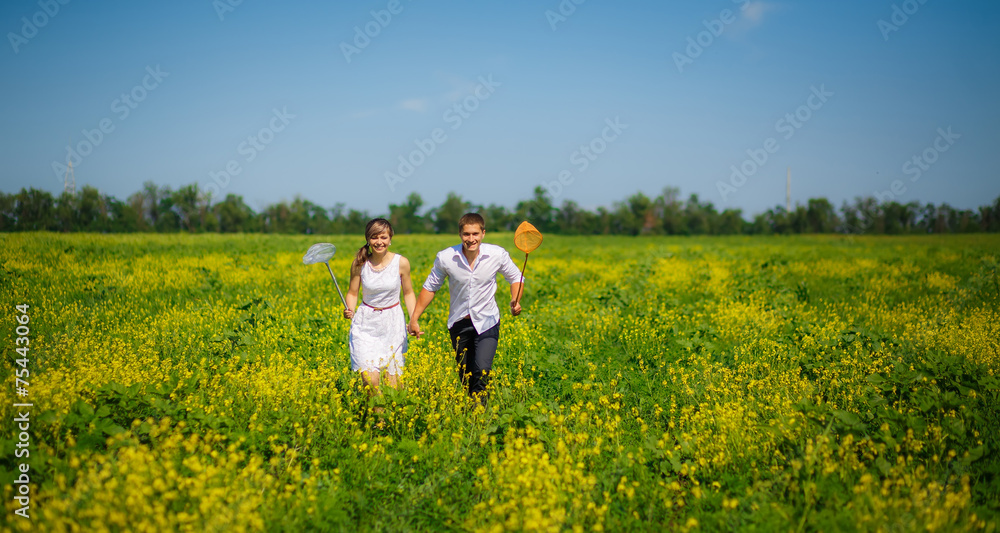 love story. man and woman to catch butterfly nets love story. man and woman to catch butterfly nets