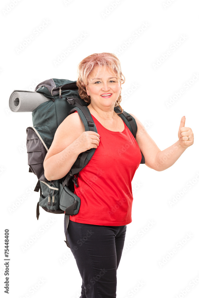 Mature lady with hiking equipment giving thumb up Mature lady with hiking equipment giving thumb up