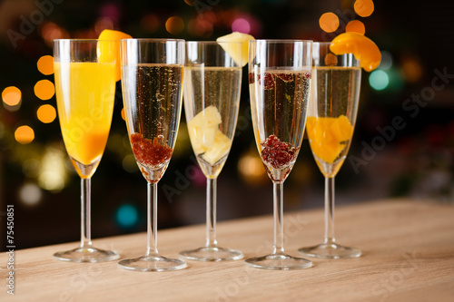 Five glasses of champagne with fruit