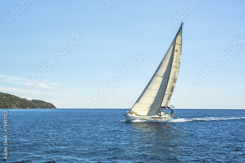 Sailing yachts with white sails.