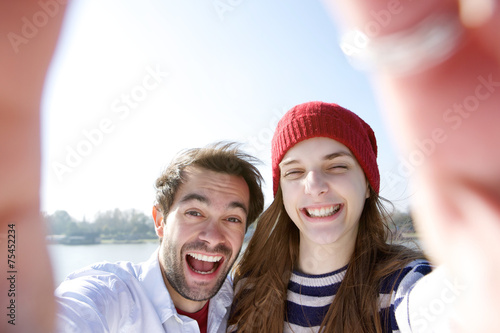 Young couple having fun and taking selfie