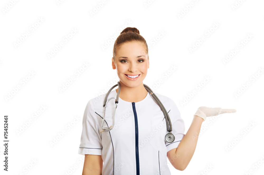 Female doctor presenting copyspace on the right Female doctor presenting copyspace on the right