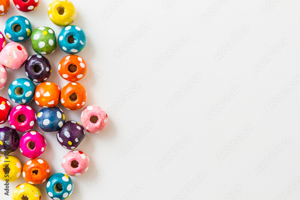 Multi Colored Beads on white background with copy space Multi Colored Beads on white background with copy space