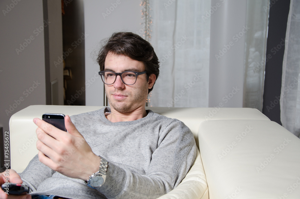 junger Mann zappt und liest Nachricht auf Smartphione junger Mann zappt und liest Nachricht auf Smartphione