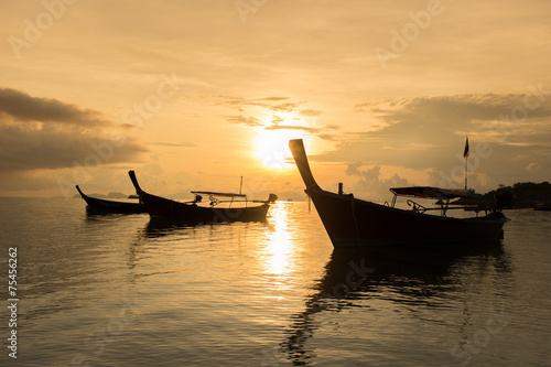 Silhouette of boat at Sunrise © annopk