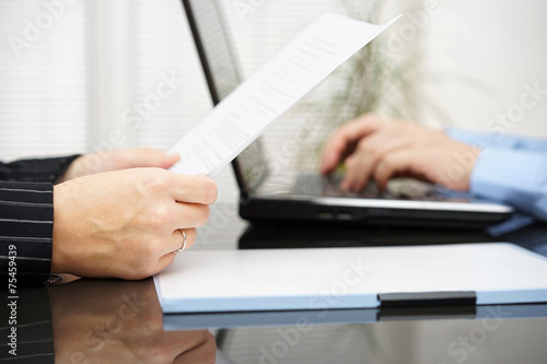 Konstfotografi Lawyer is reading contract and bussiness client is typing on lap