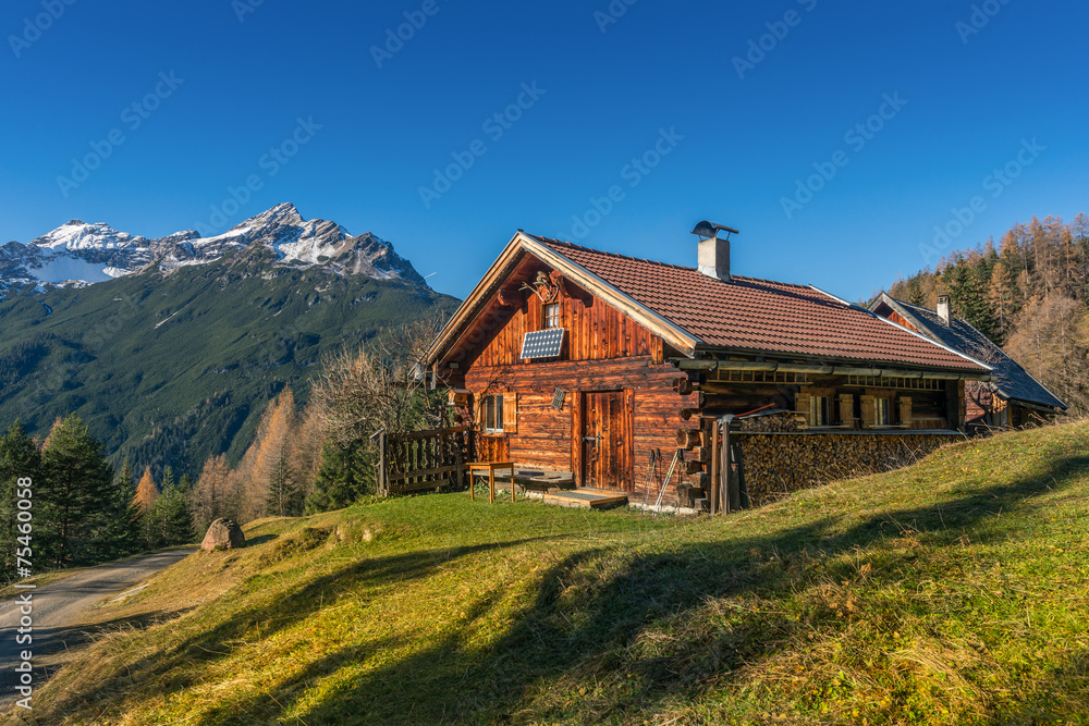 Obraz premium old wooden hut cabin in mountain alps at rural fall landscape
