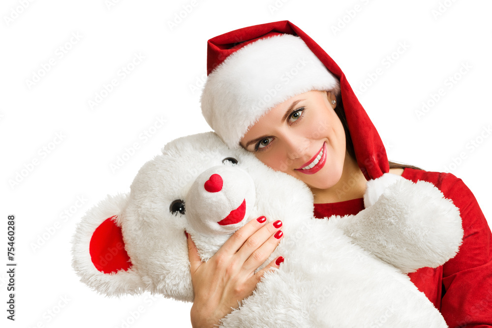 Woman in red santa hat smiling and holding toy bear Woman in red santa hat smiling and holding toy bear
