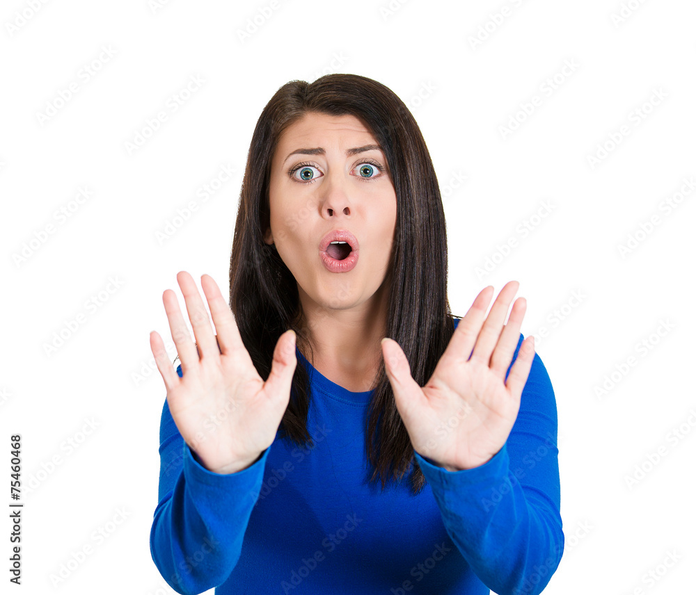 Fototapeta premium Cautious afraid annoyed displeased woman raising hands stop