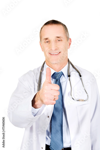 Portrait of confident male doctor with thumb up