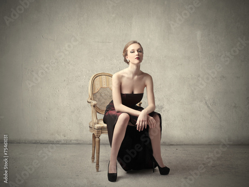 Classy woman sitting on a chair