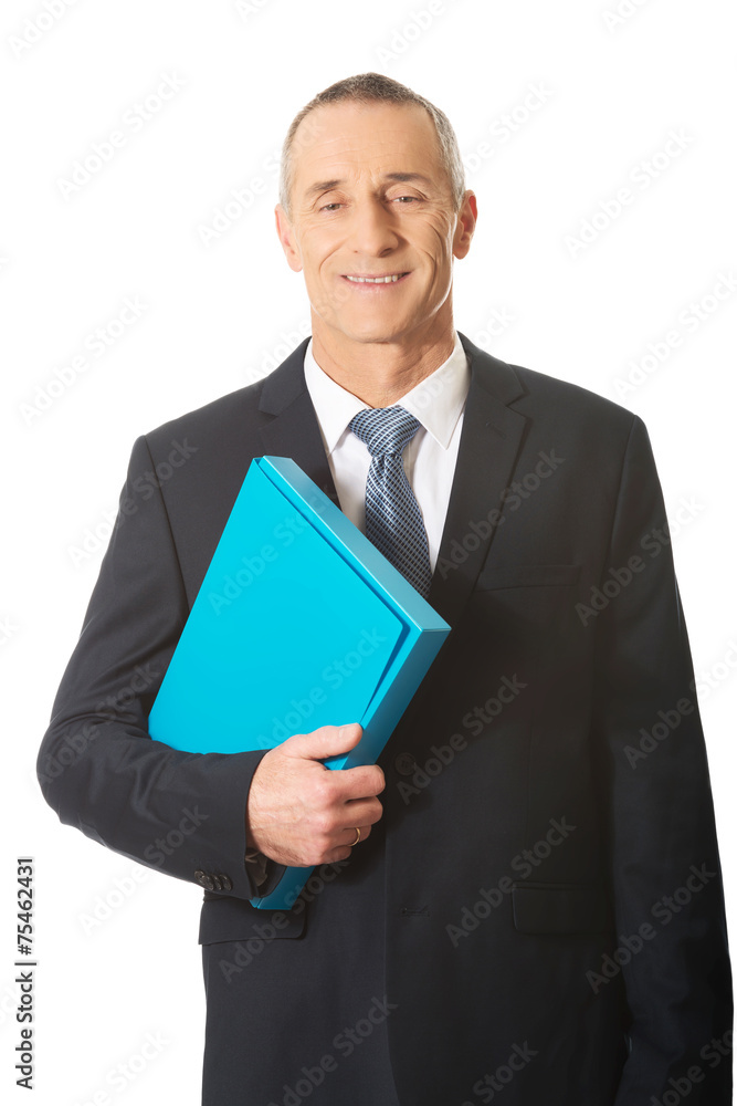 Portrait of mature businessman holding a binder Portrait of mature businessman holding a binder