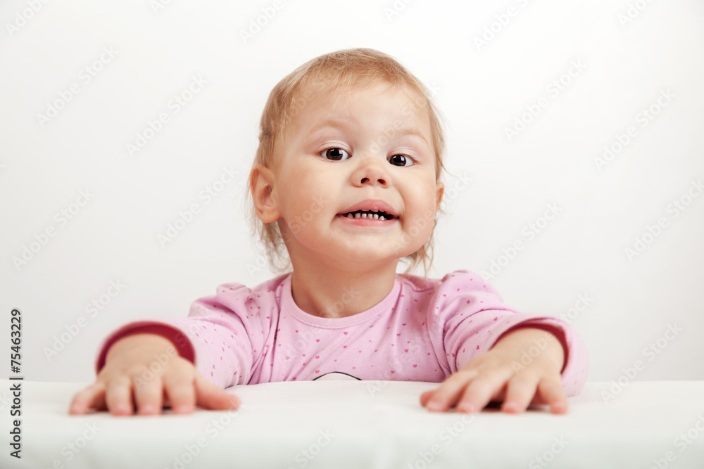 Funny Caucasian baby girl in pink on white background Funny Caucasian baby girl in pink on white background