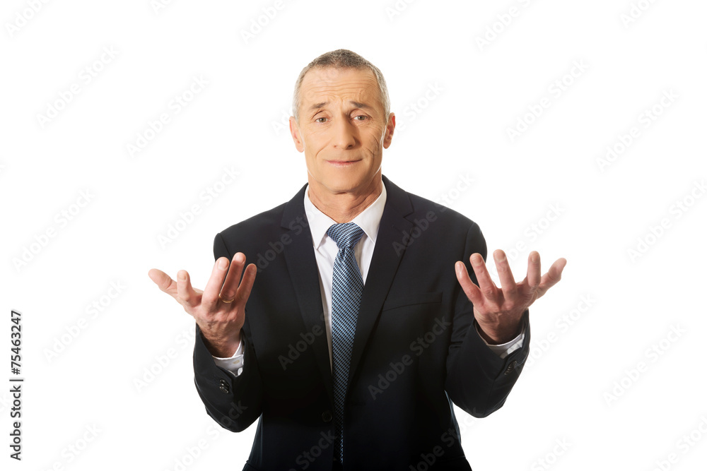 Businessman with hands open in undecided gesture Businessman with hands open in undecided gesture