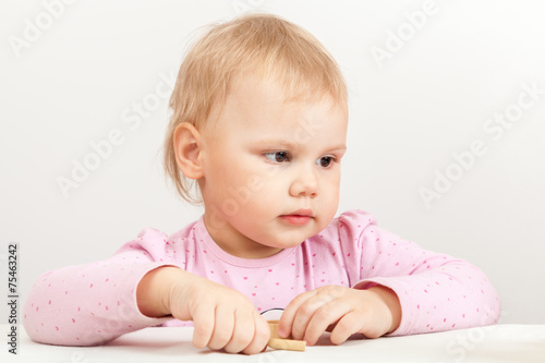 Cucasian baby girl in pink on white background