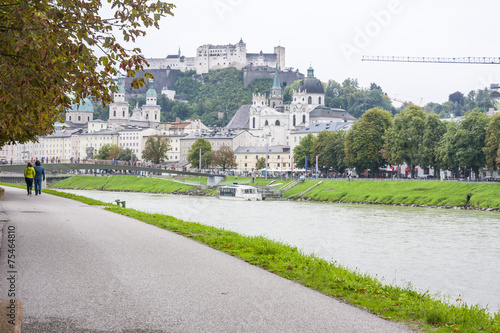 Panoramic view of Salzburg skyline with Festung Hohensalzburg and river Salzach in rainy day, Salzburger Land, Austria