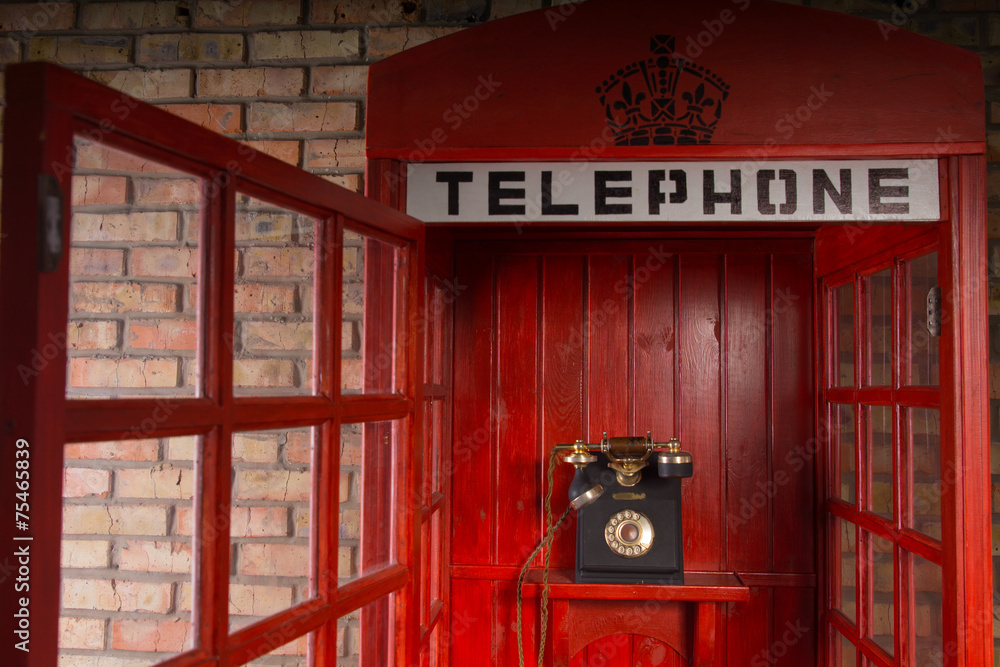 Obraz premium Red Public Telephone Booth with Open Door