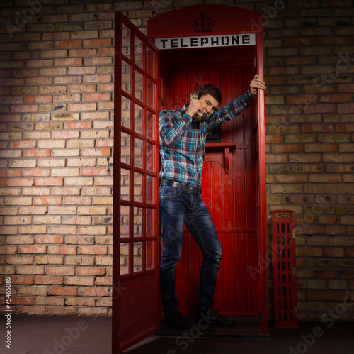 Wallpaper Mural Man standing chatting in a phone booth Torontodigital.ca