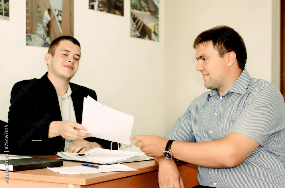 Salesman or broker handing over a contract Salesman or broker handing over a contract