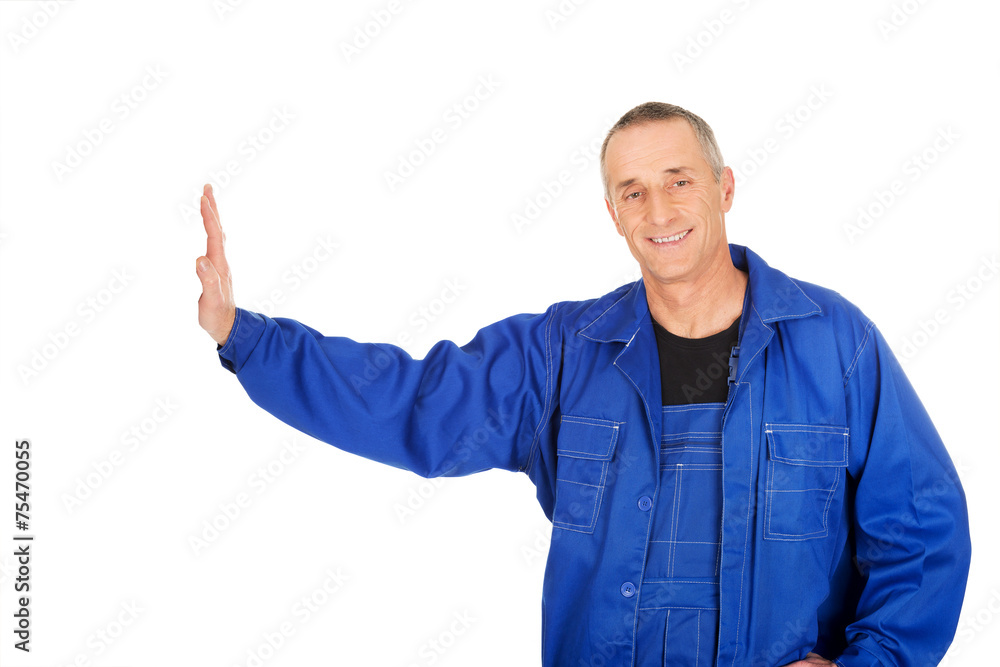Smiling repairman against the wall Smiling repairman against the wall