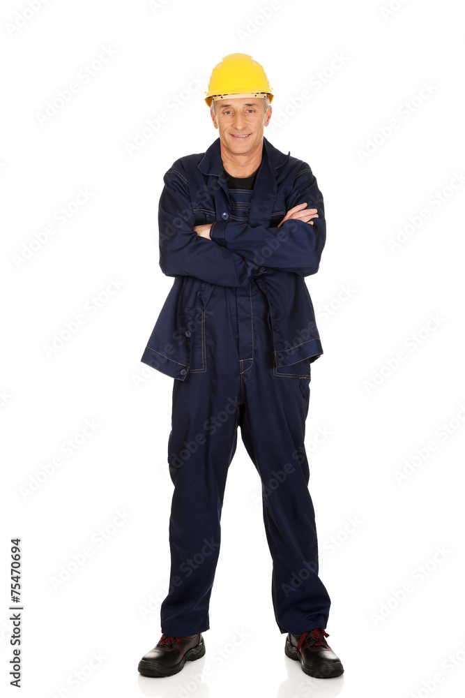 Full length smiling constructor with folded arms Full length smiling constructor with folded arms