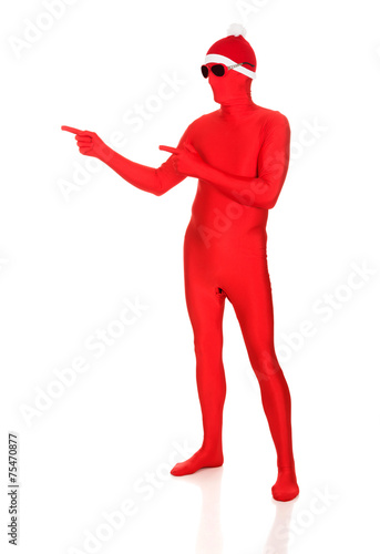 Full length santa man in latex clothing pointing