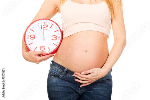 Pregnant woman with a big clock