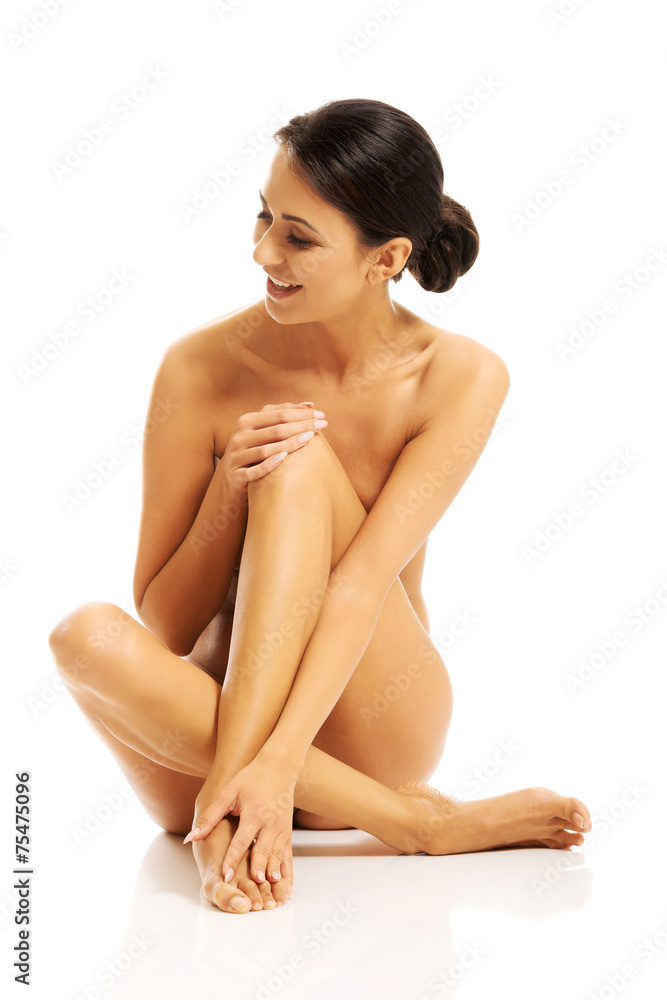 Slim nude woman laughing out loud and looking on her right