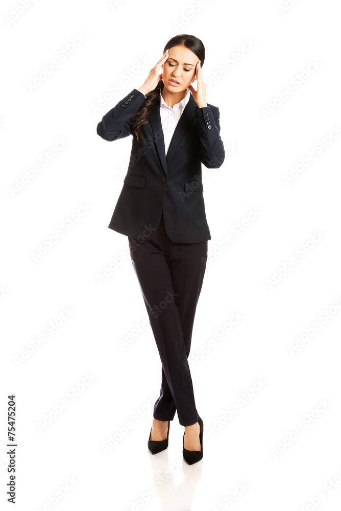 Full length businesswoman having huge headache Full length businesswoman having huge headache
