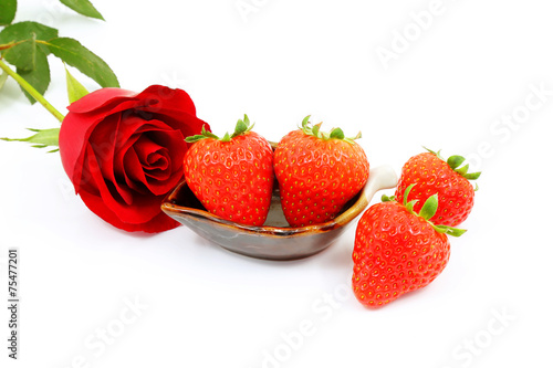 A Red Rose and Strawberries on a White Background