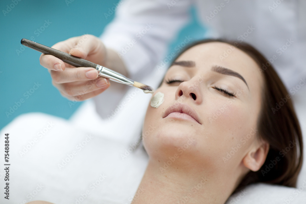 A young woman with a face pack. A young woman with a face pack.