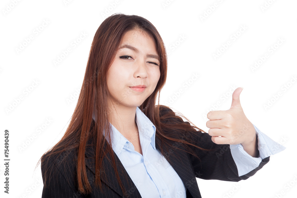 Young Asian businesswoman winks her eye and thumbs up Young Asian businesswoman winks her eye and thumbs up