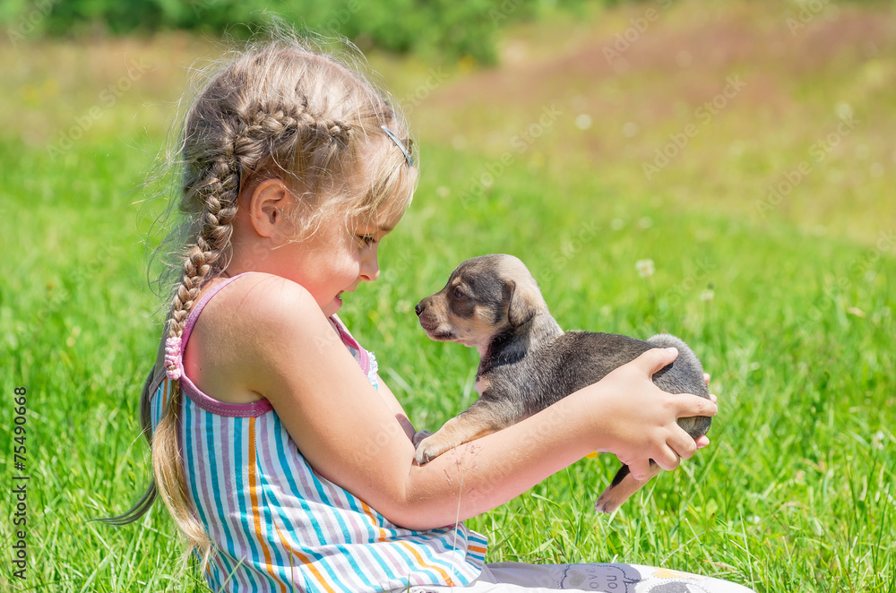 A child on a walk with a little puppy A child on a walk with a little puppy