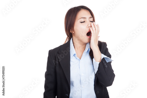Tired young Asian businesswoman yawn