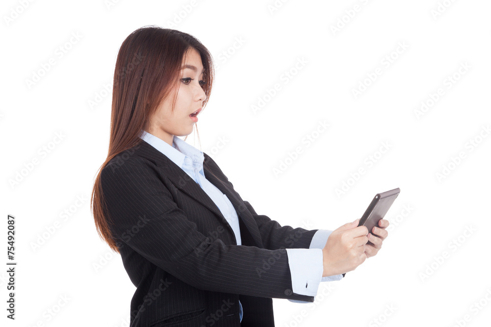 Young Asian businesswoman shocked with tablet PC Young Asian businesswoman shocked with tablet PC