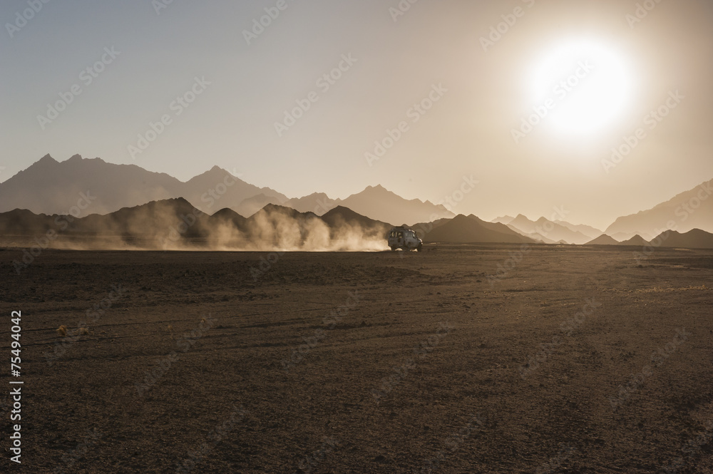 Off road safari in desert with sunset