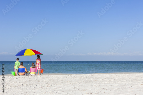 Family Alone on Beach With Umbrella © Darren Baker