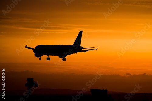 Airplane landing at sunset, Frankfurt, Germany