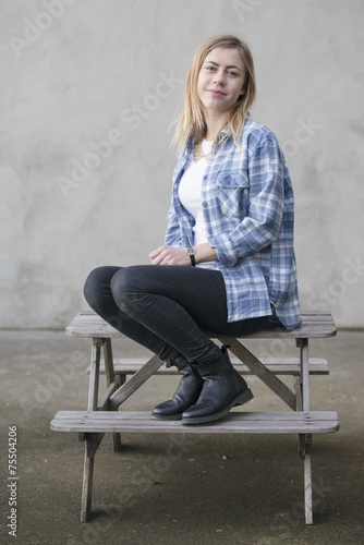 Teenage girl with blue shirt on grey background