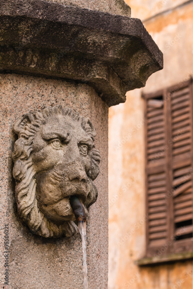 detail of lion head fountain in Cannobio, Italy