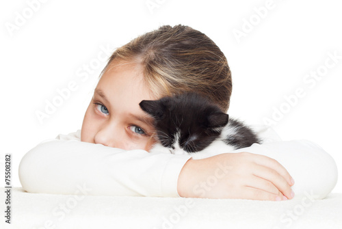 kid tenderly embraces kitten