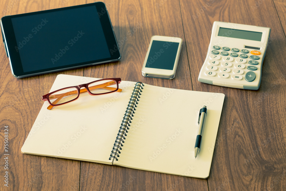 Ring binger notebook and tablet mobile phone on wood background Ring binger notebook and tablet mobile phone on wood background