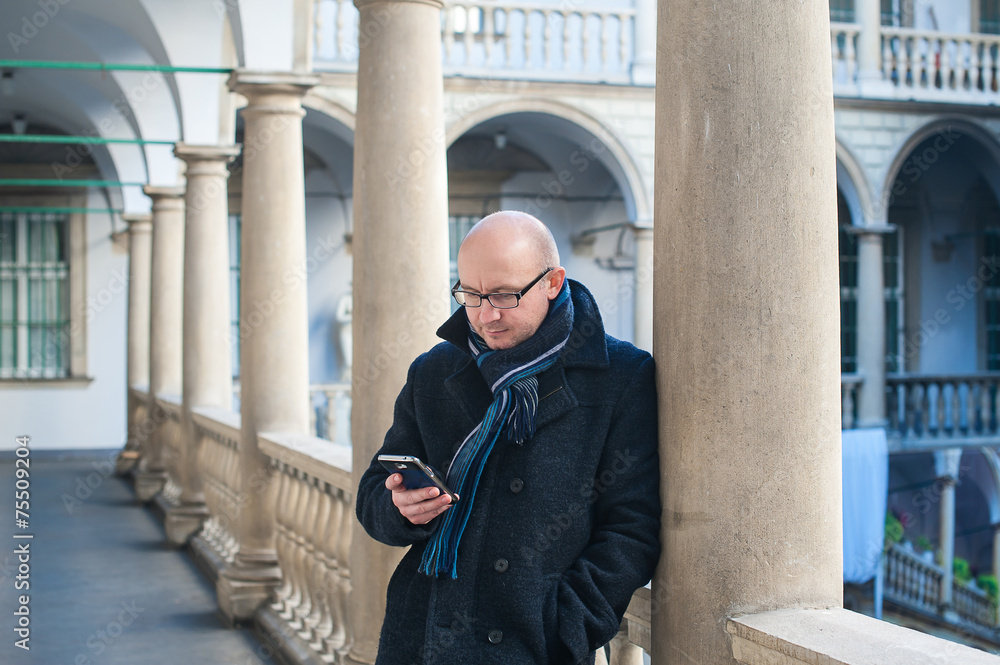 man with a phone at the column