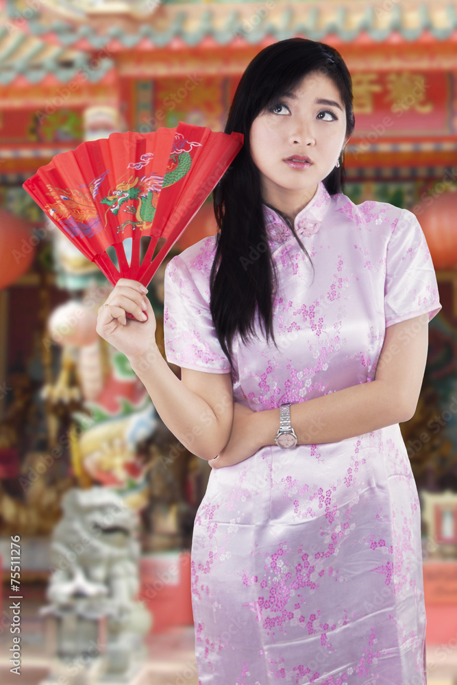 Chinese girl in cheongsam clothes at temple Chinese girl in cheongsam clothes at temple