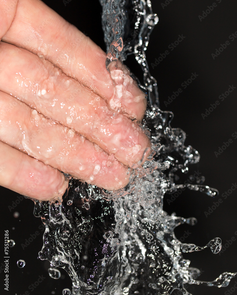 Fototapeta premium hand in water on a black background
