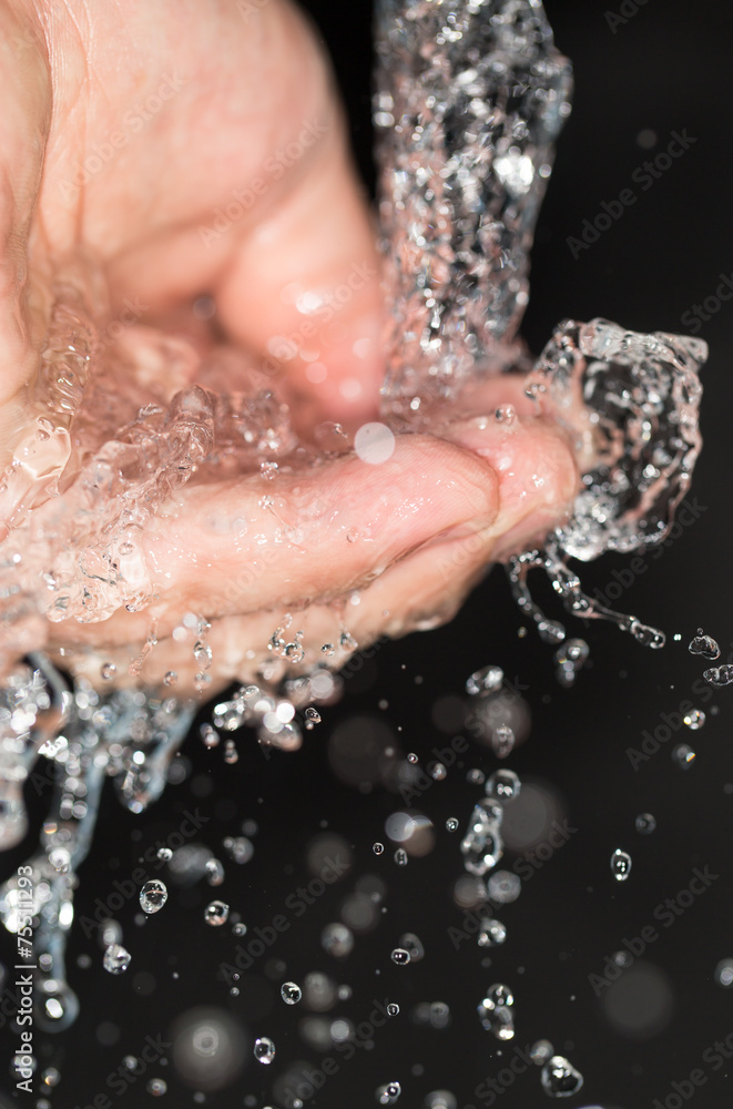 Fototapeta premium hand in water on a black background
