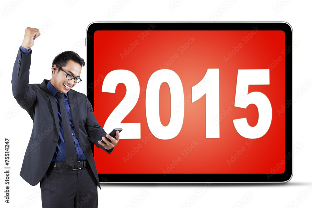 Male entrepreneur with cellphone and numbers 2015 Male entrepreneur with cellphone and numbers 2015