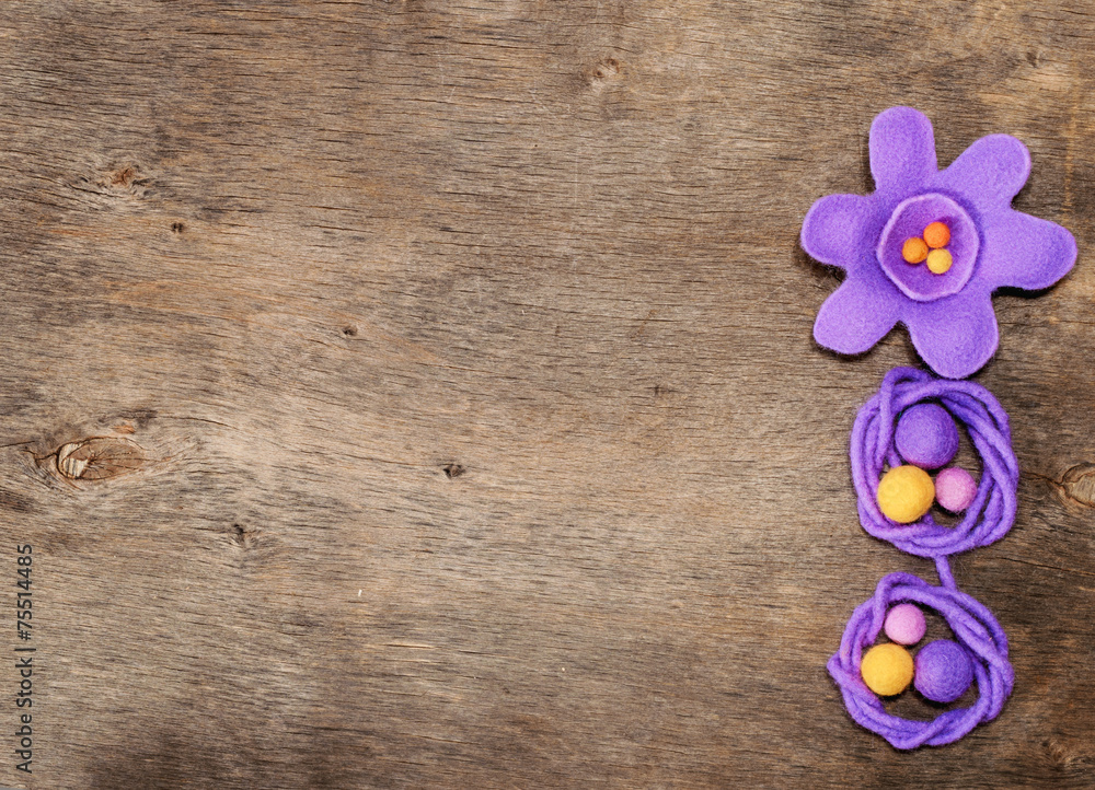 purple flower and beads from felt and place for text purple flower and beads from felt and place for text